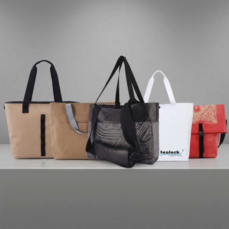 Row of finished custom waterproof totes in different closures handle lengths and colours