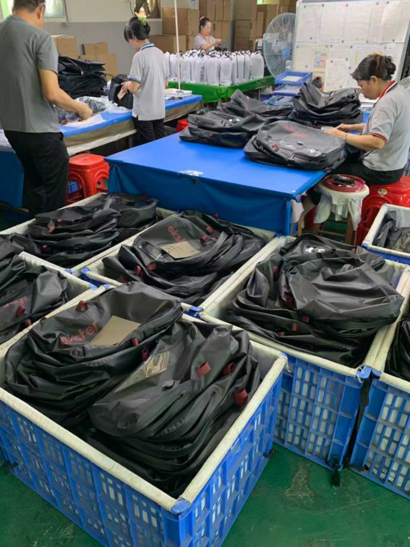 Finished bags sorted into cloth-lined bins with count cards, second program running alongside