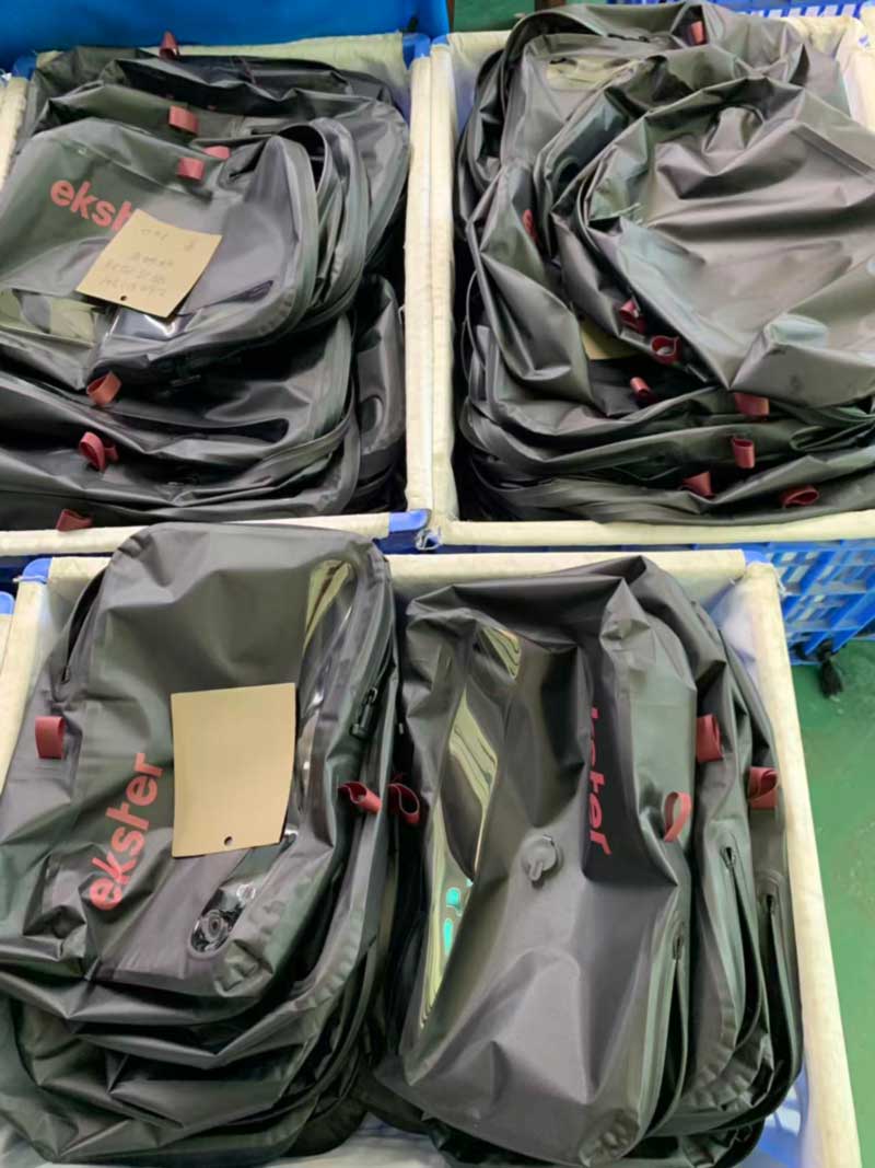 Finished IPX7 welded travel bags with airtight zipper and valve in a lined bin