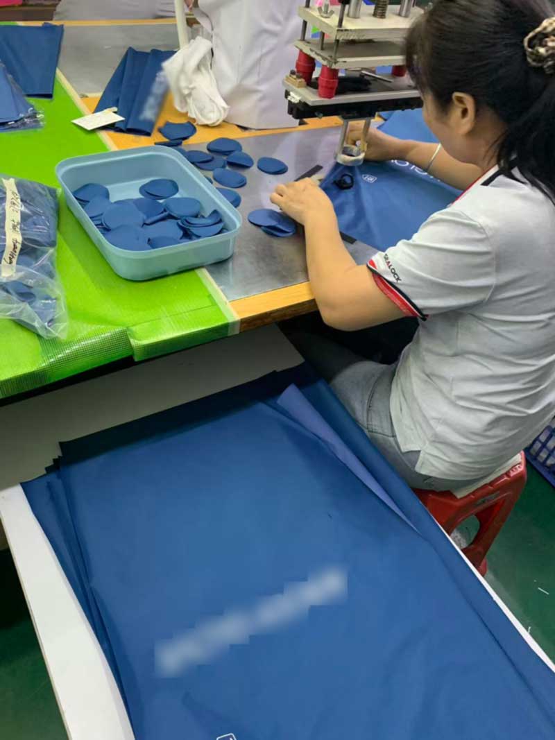 Custom copper welding die mounted in the press beside the bag shape it produces