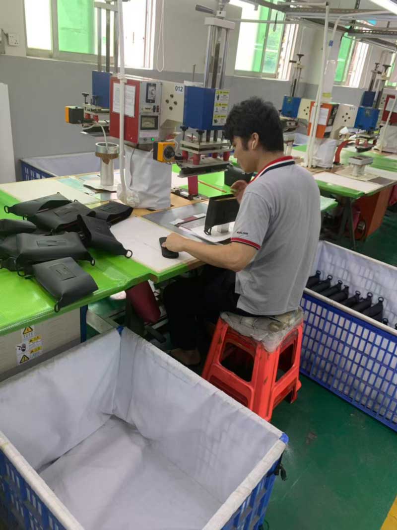 Row of numbered high-frequency welding stations, each with its own die and component bin