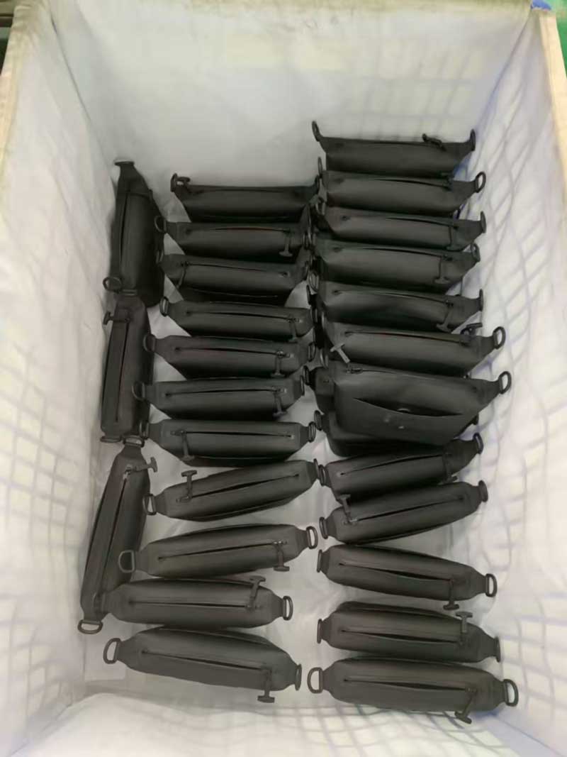 Rows of finished welded sling bags arranged in a lined bin