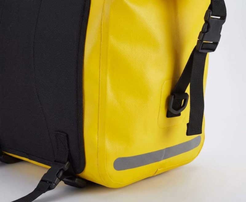 Welded PVC pannier seam with reflective strip and dual strap mounting system