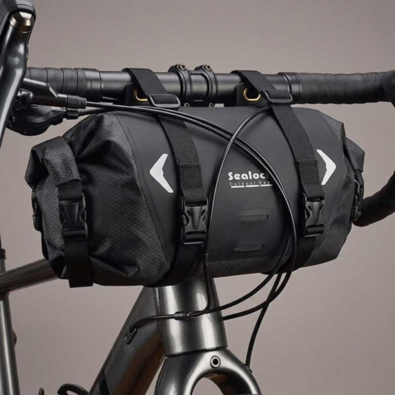 Handlebar roll straps through welded ports with cables routed clear of the bag